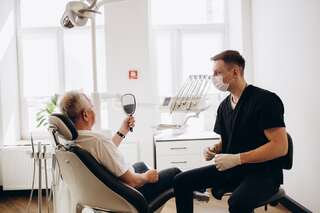 senior man having dental treatment at dentist s office